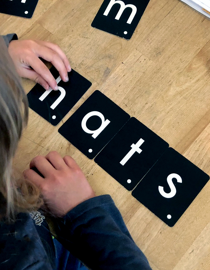 Homeschool student with mild special needs works on phonics with tactile letters