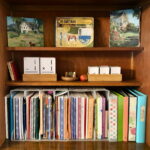 Book shelves set up for homeschooling with Memoria Press materials
