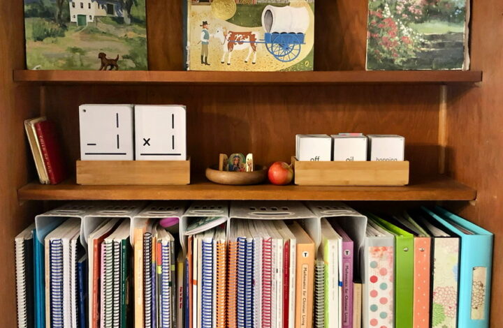 Book shelves set up for homeschooling with Memoria Press materials